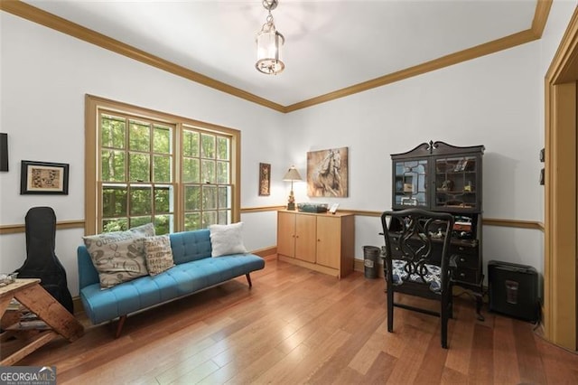 living area with crown molding and wood-type flooring