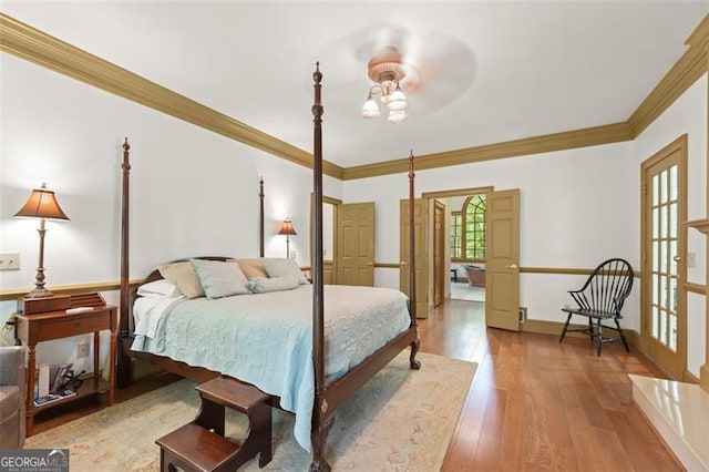 bedroom featuring crown molding, ceiling fan, and hardwood / wood-style floors