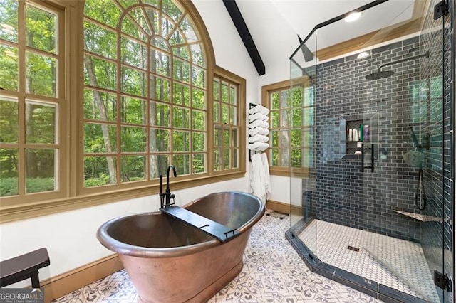 bathroom with tile patterned floors, independent shower and bath, and vaulted ceiling with beams