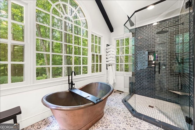 bathroom with vaulted ceiling, a healthy amount of sunlight, and separate shower and tub