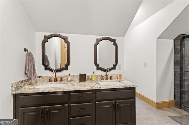 bathroom featuring lofted ceiling, tile patterned floors, and vanity