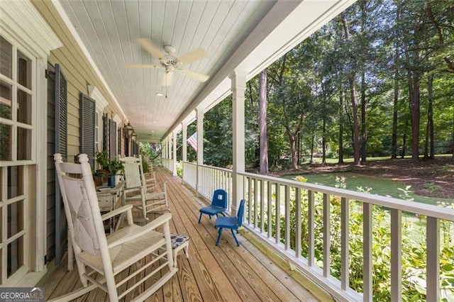 deck with ceiling fan and covered porch