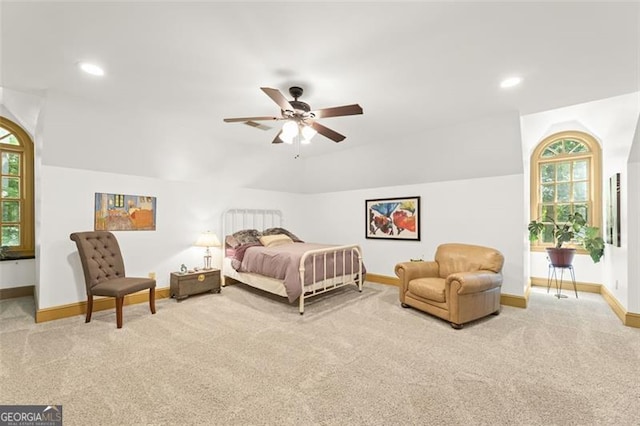 bedroom featuring multiple windows, ceiling fan, and light carpet