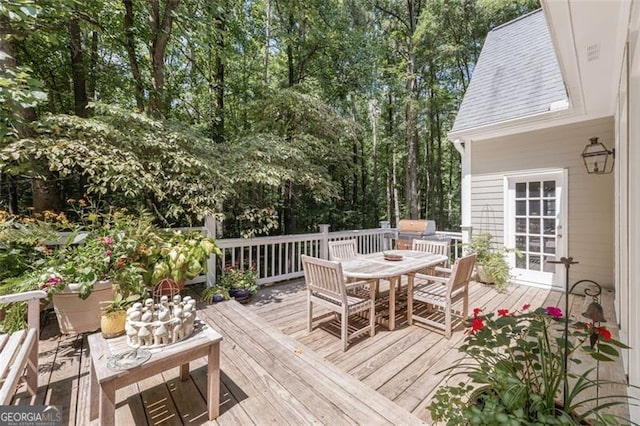 wooden terrace featuring a grill