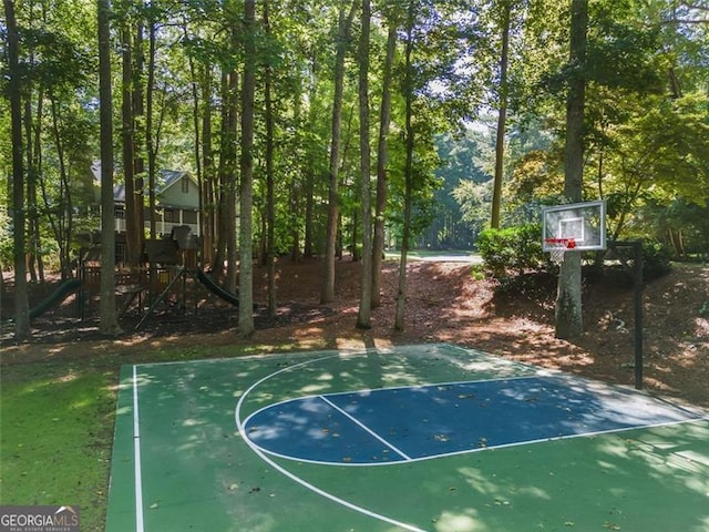 view of sport court featuring a playground