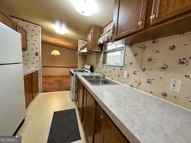 kitchen featuring light tile patterned flooring, sink, hanging light fixtures, and white appliances