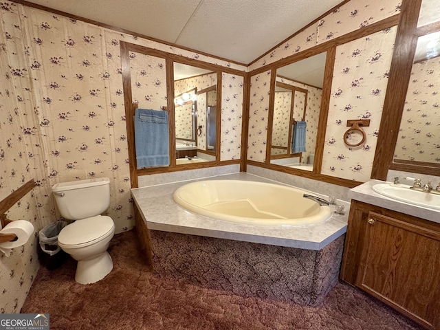 bathroom with vaulted ceiling, a textured ceiling, vanity, a washtub, and toilet