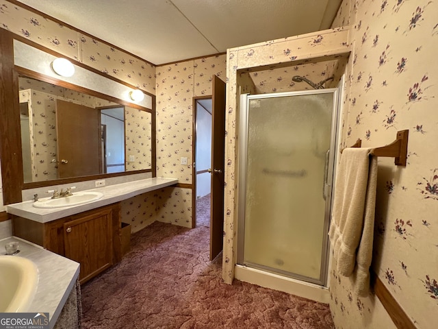 bathroom featuring a textured ceiling, a shower with door, and vanity