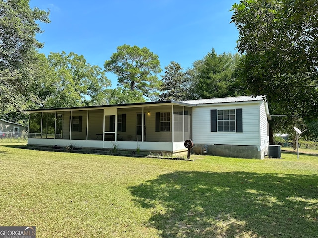 view of front of home featuring a front lawn and a sunroom