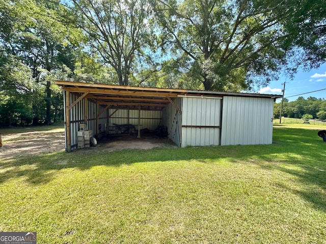 view of outbuilding featuring a lawn