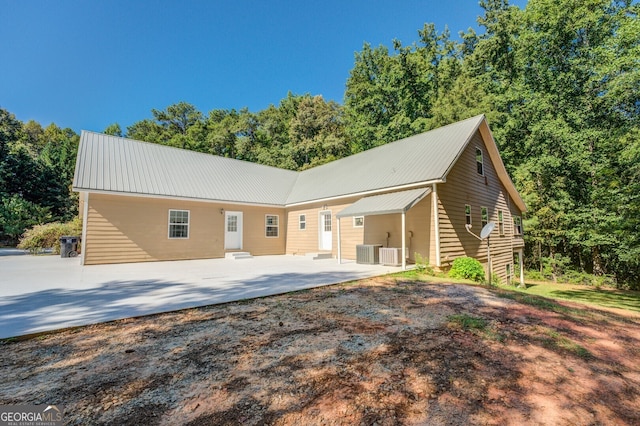 view of front of property featuring a patio area and central AC