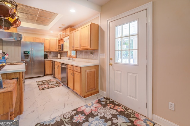 kitchen featuring backsplash, appliances with stainless steel finishes, a raised ceiling, light tile patterned floors, and light brown cabinetry