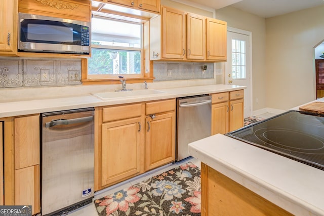 kitchen with sink, stainless steel appliances, decorative backsplash, and light brown cabinetry