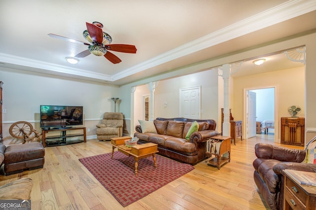 living room with light hardwood / wood-style flooring, ceiling fan, ornamental molding, and decorative columns