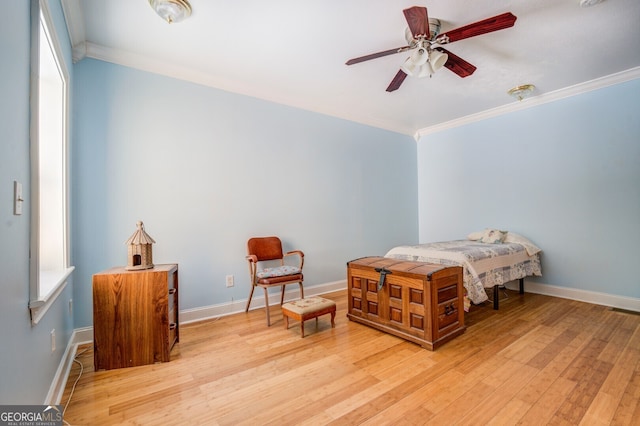 bedroom with ceiling fan, light hardwood / wood-style flooring, and crown molding