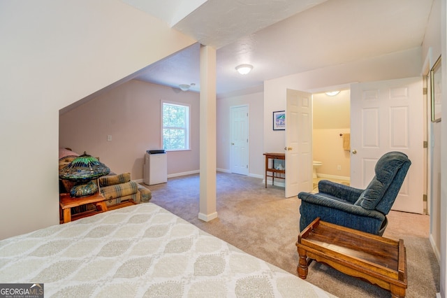 bedroom with light carpet and ensuite bathroom