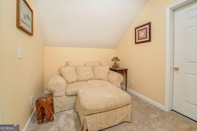 sitting room featuring light carpet and lofted ceiling