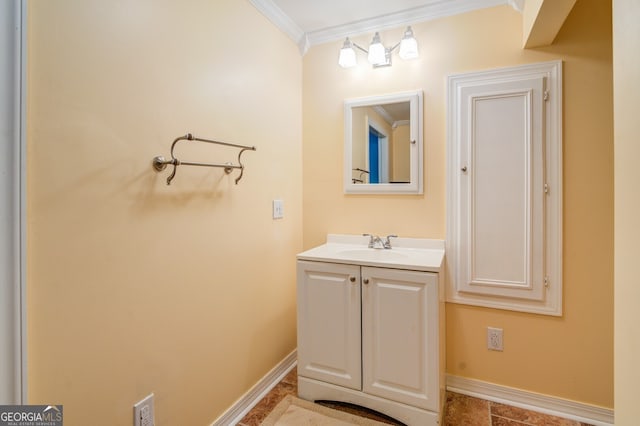 bathroom featuring tile patterned flooring, crown molding, and vanity