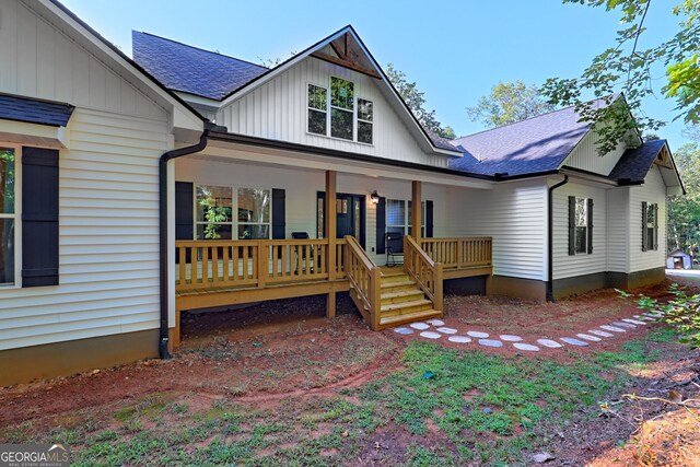 rear view of house with covered porch