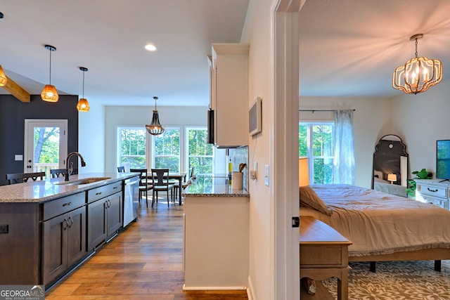 bedroom with sink, hardwood / wood-style floors, and a notable chandelier