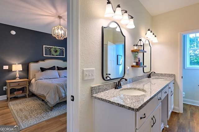 bathroom featuring a chandelier, wood-type flooring, and vanity