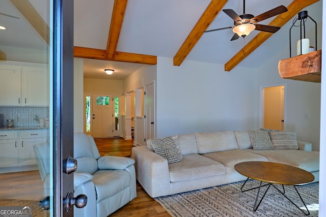 living room featuring ceiling fan, lofted ceiling with beams, and dark hardwood / wood-style flooring