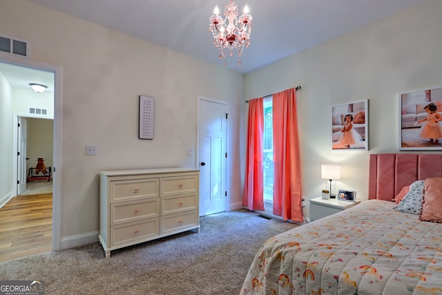 carpeted bedroom featuring a notable chandelier