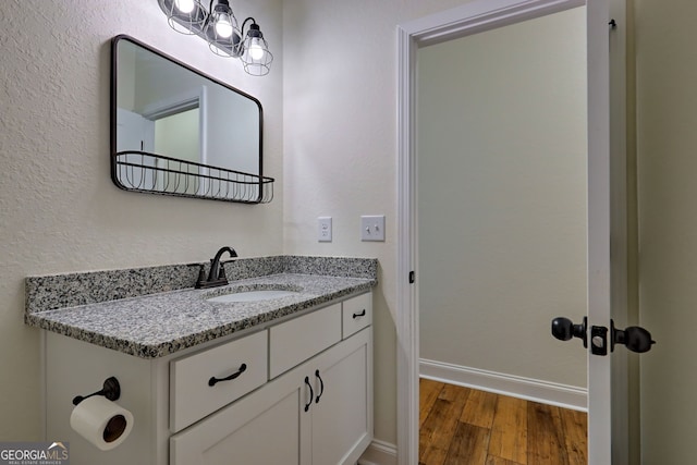 bathroom with vanity and hardwood / wood-style floors