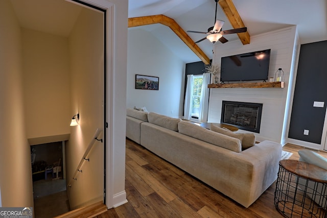 living room featuring a fireplace, hardwood / wood-style floors, lofted ceiling with beams, and ceiling fan