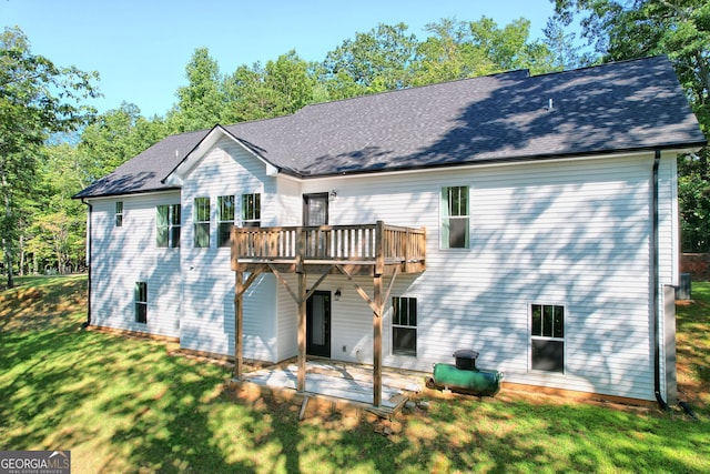 back of property featuring a yard, a patio, and a deck