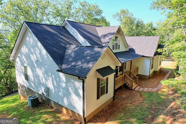 view of side of home featuring central AC