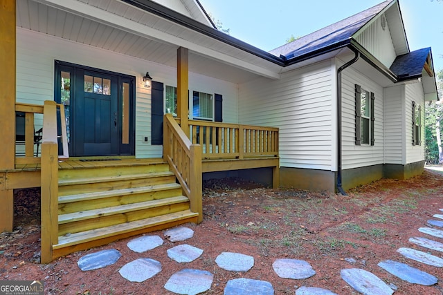 view of exterior entry with a porch