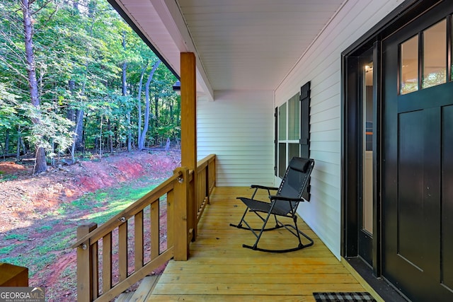 wooden terrace featuring covered porch