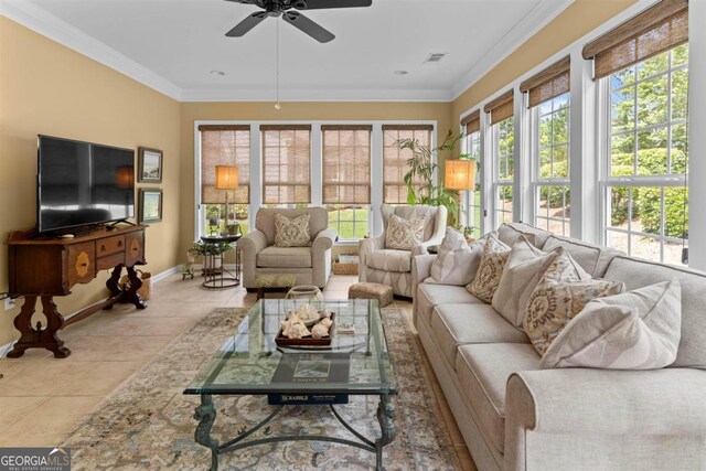 tiled living room with ceiling fan and crown molding