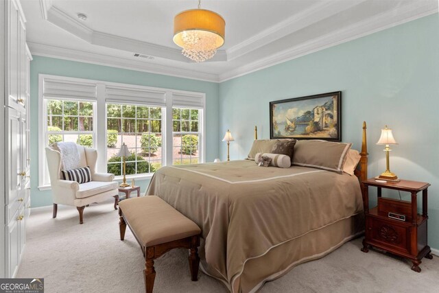 bedroom with a raised ceiling, ornamental molding, and light carpet