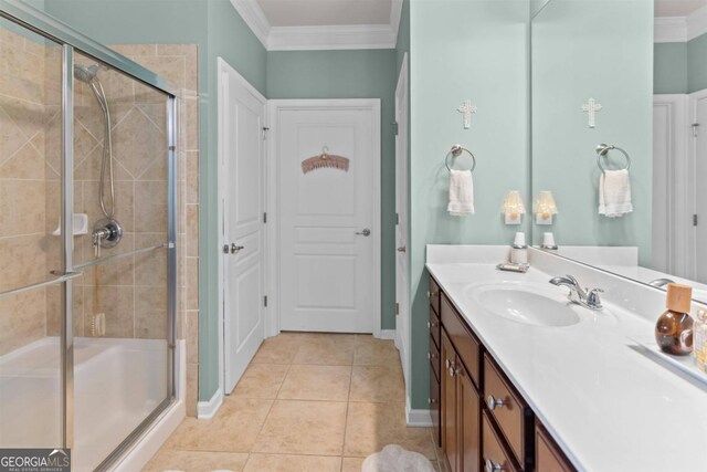 bathroom with tile patterned flooring, walk in shower, vanity, and ornamental molding