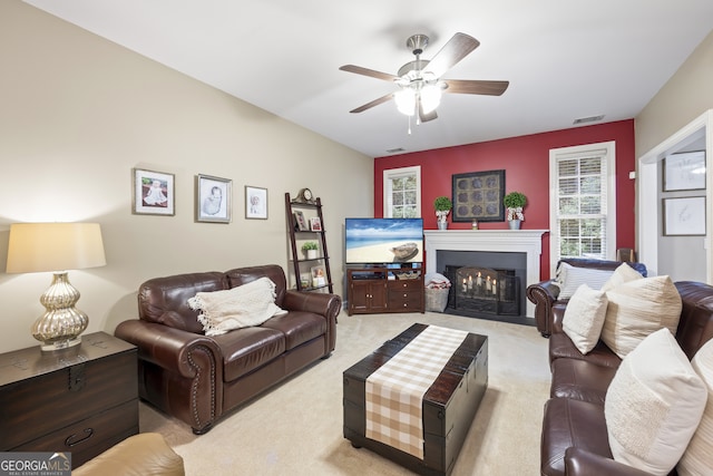 carpeted living room with ceiling fan