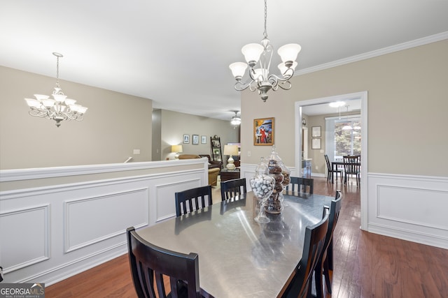 dining room with crown molding, dark wood-type flooring, and a notable chandelier