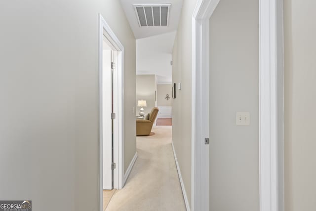 hall featuring light colored carpet