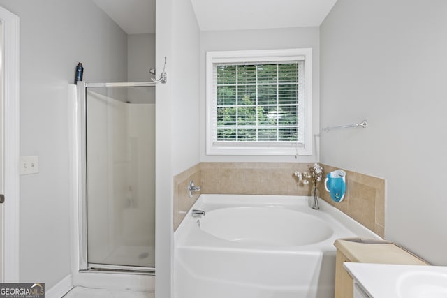 bathroom featuring plus walk in shower and vanity