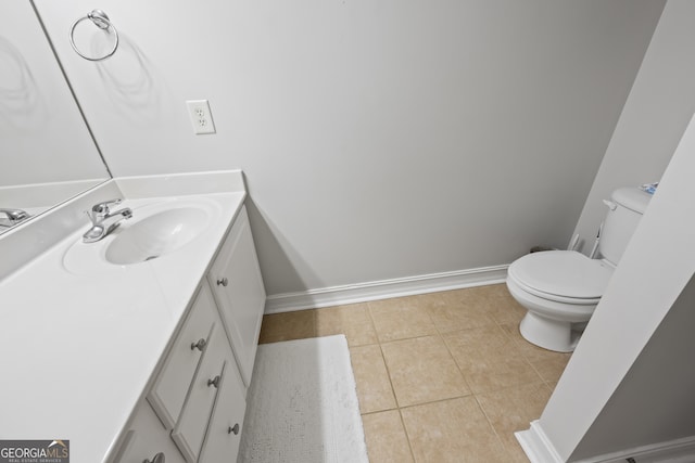 bathroom with tile patterned flooring, vanity, and toilet