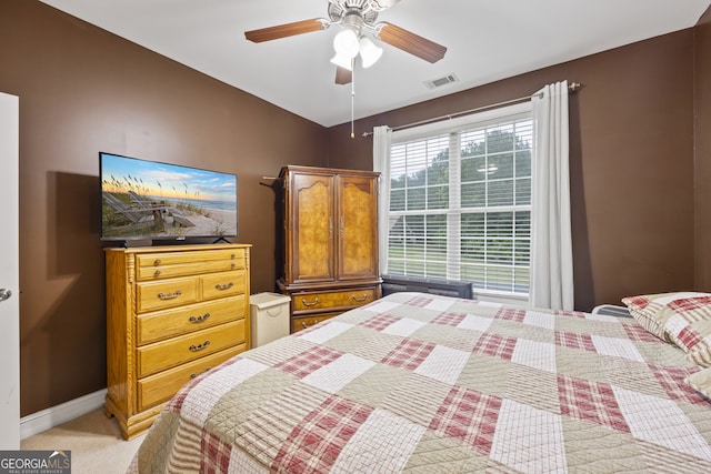 bedroom featuring ceiling fan, vaulted ceiling, and light carpet