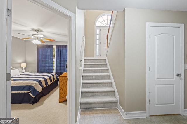 interior space with ceiling fan