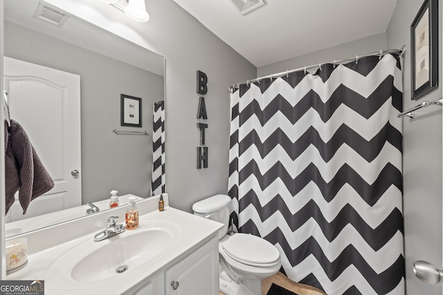 bathroom featuring toilet and vanity