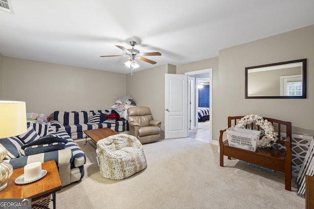 living room with ceiling fan and light colored carpet