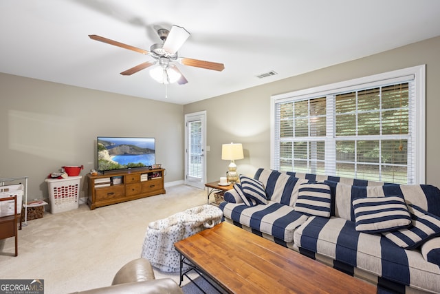 living room with ceiling fan and light carpet