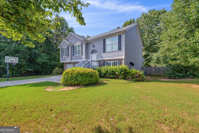 raised ranch with a front yard