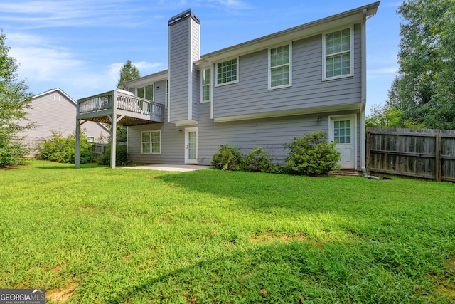 rear view of house with a yard