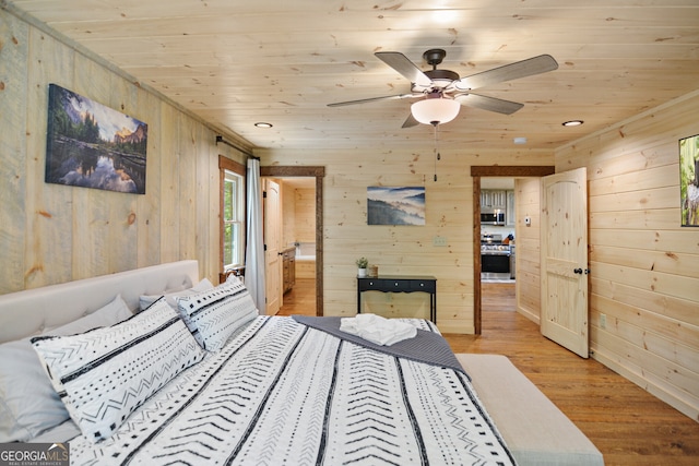 bedroom featuring light wood-type flooring, wood ceiling, ceiling fan, and wood walls