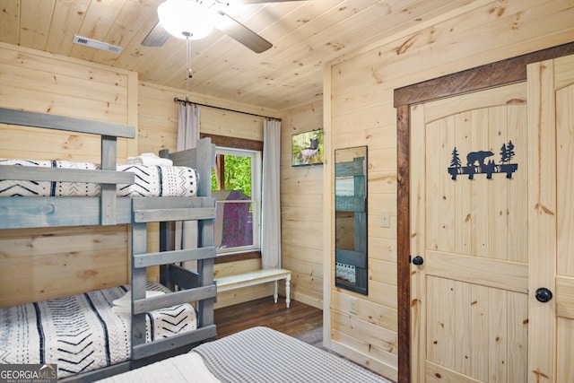 bedroom featuring wood walls, wood ceiling, ceiling fan, and dark hardwood / wood-style flooring